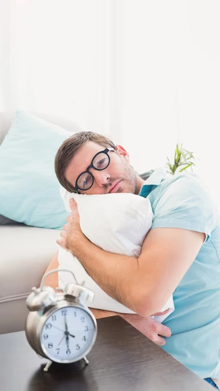 a men who wear sky blue t- shirt sleeping on white pillow