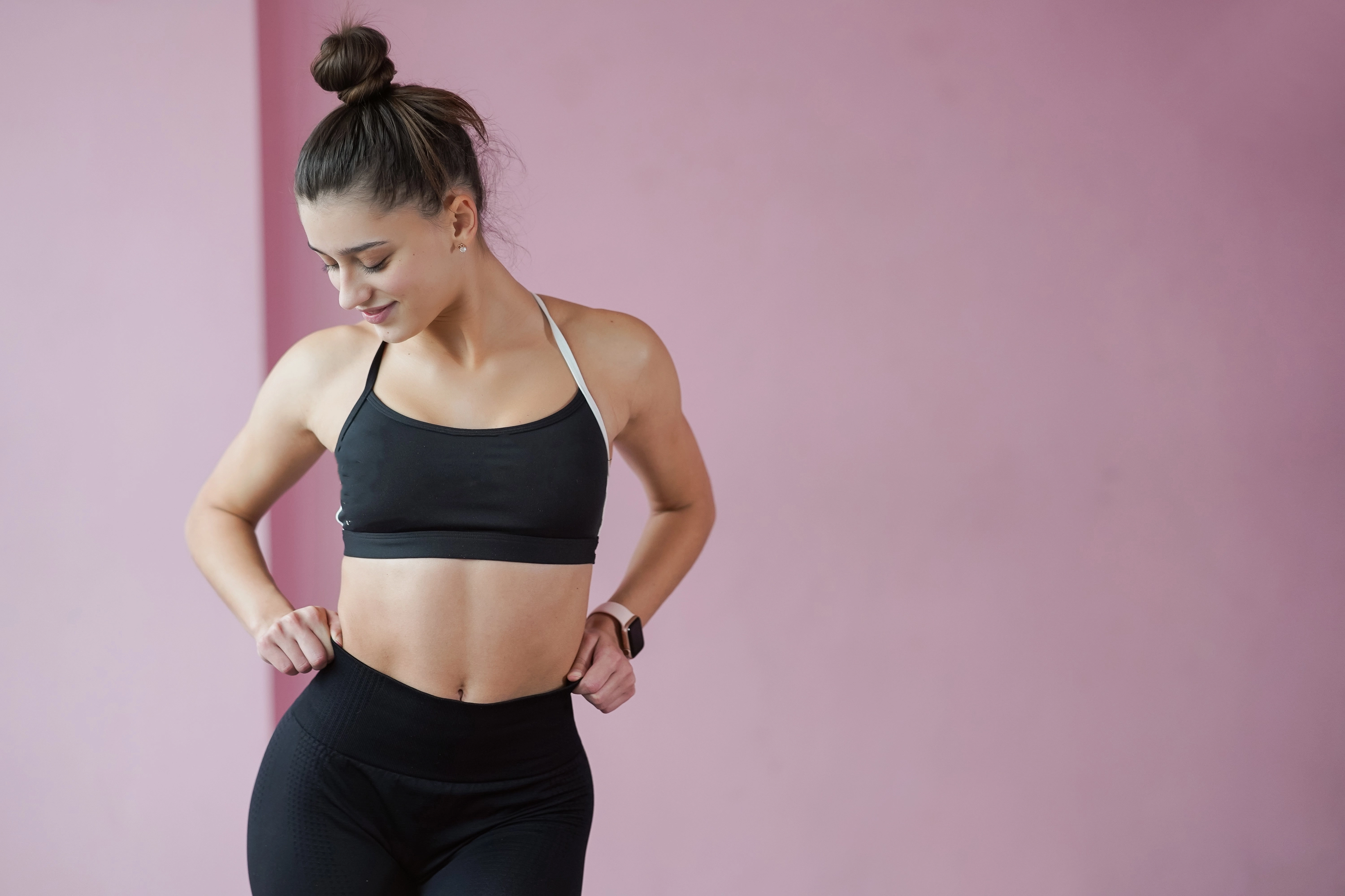 a girl wearing sports poising slim front of the camera