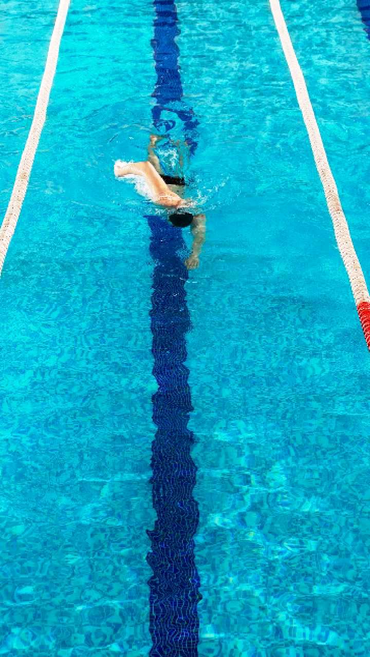 three-male-swimmers-racing-against-each-other - Fitness Stories